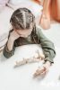 a girl playing a wooden toy at the table 3662941 scaled