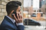 man in blue suit holding smartphone 374008 scaled