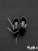 pair of black and white adidas sneakers on grey floor 1407354 scaled