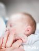 tilt shift lens photo of infant s hand holding index finger 895515 scaled