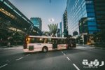white bus on road near in high rise building during daytime 68427 scaled