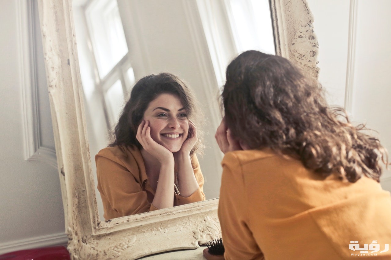 photo of woman looking at the mirror 774866